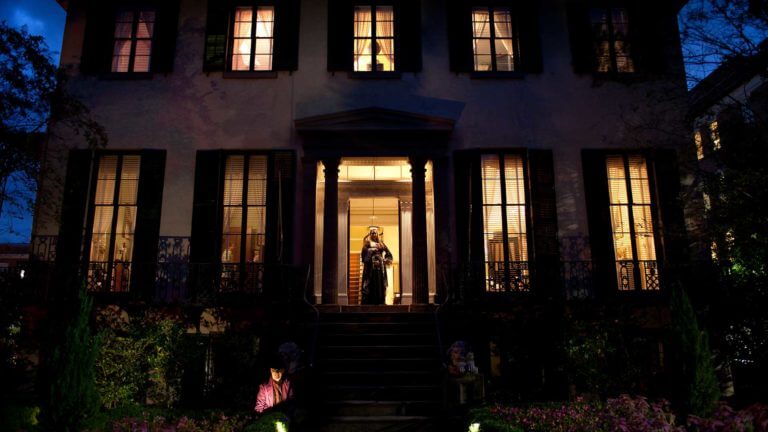 andrew low house at night with haunted tour guide at the door