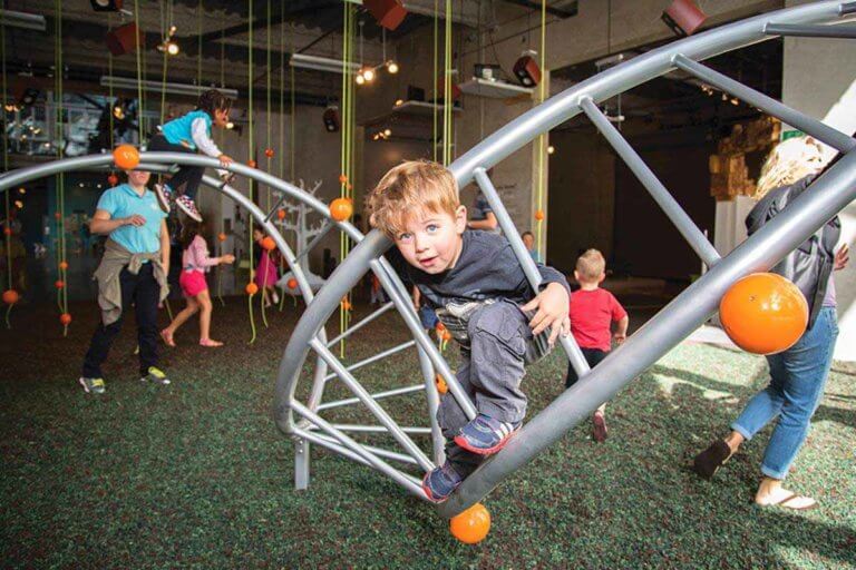 child playing in jungle gym at san diego childrens museum