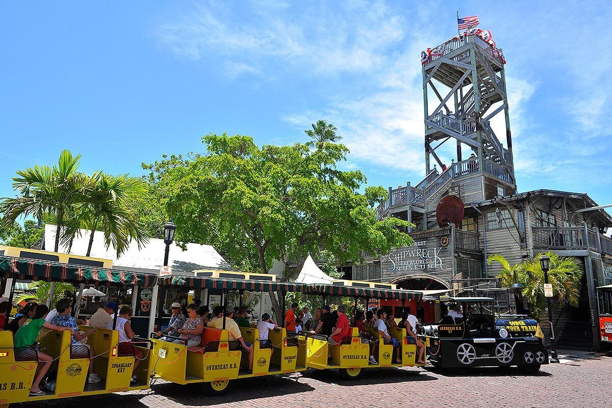 Key West Conch Tour Train driving past Shipwreck Museum