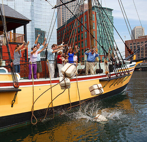 Guests throwing tea overboard at Boston Tea Party Ships & Museum