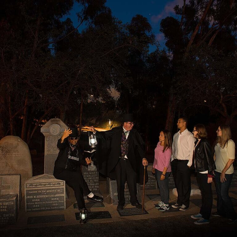 San Diego ghost tour hosts and guests at cemetery