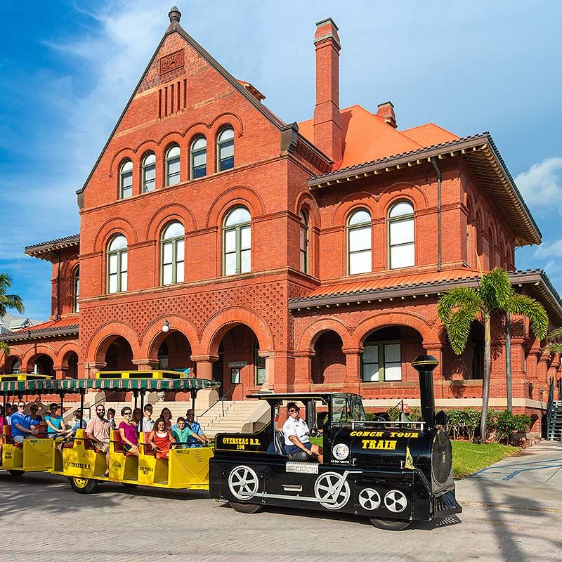 Key West Conch Tour Train driving by Customs House