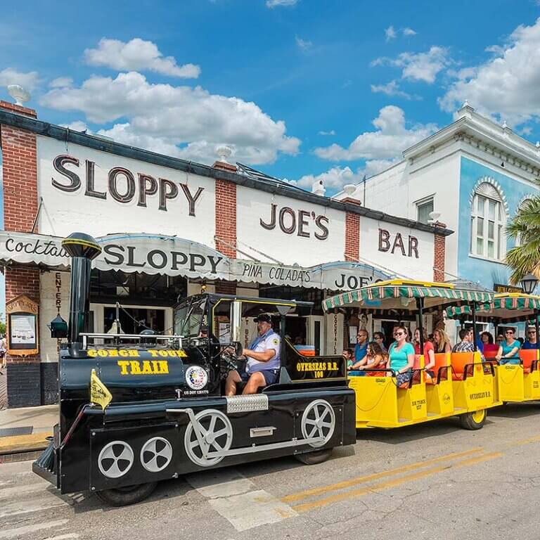 Conch Tour Train driving by Sloppy Joes