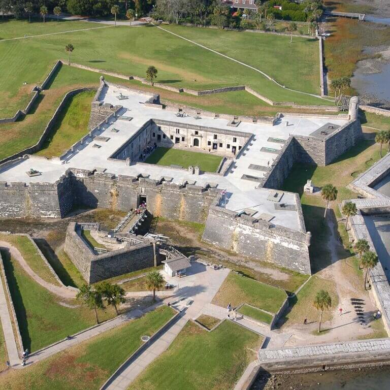 A view of the Castillo de San Marcos, a fortress with a moat and drawbridge.