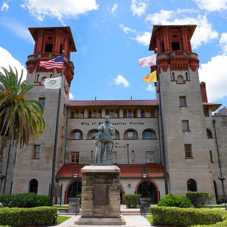 Exterior of Lightner Museum in St. Augustine, showcasing historic architecture and lush greenery.