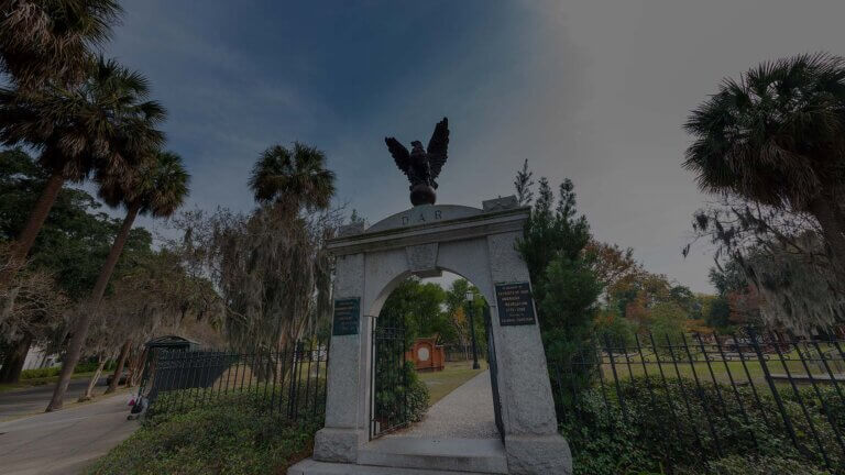 A serene view of Colonial Park Cemetery in Savannah, showcasing historic gravestones amidst lush greenery.