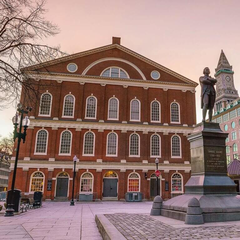 Faneuil Hall in Boston, a historic marketplace and meeting hall, bustling with visitors and vibrant shops