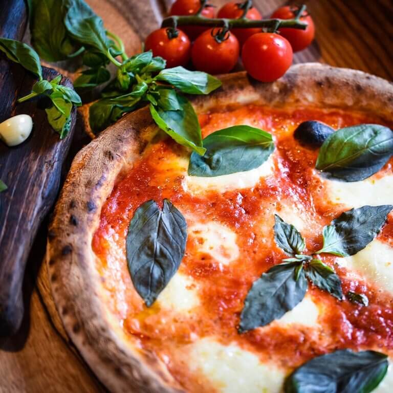 vibrant spread of Italian dishes featuring pasta, pizza, and fresh ingredients