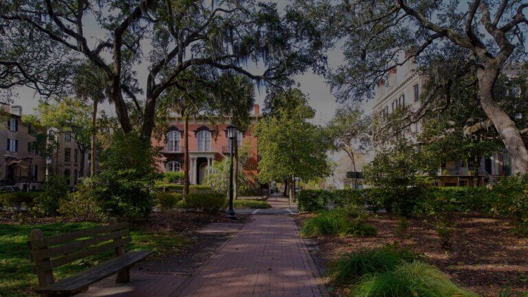 Monterey Square with vibrant foliage and elegant historic structures