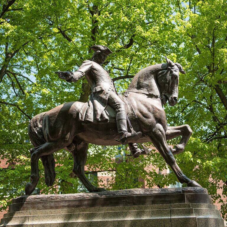 A historic scene of Paul Revere riding through the night