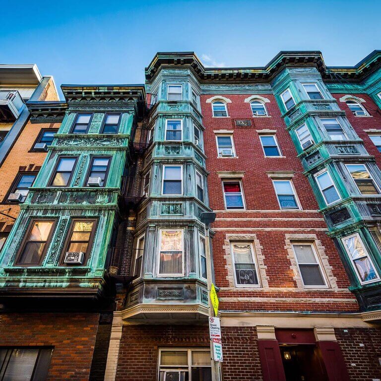 A charming street in North End, Boston with historic buildings and cobblestone sidewalks