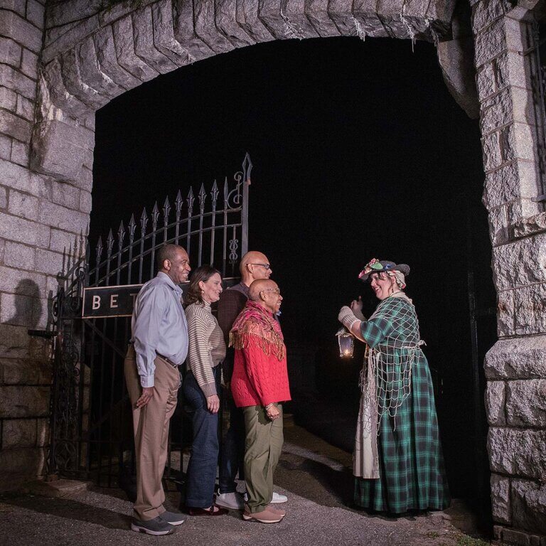 Charleston ghost tour guests and hosts walking into Bethany Cemetery