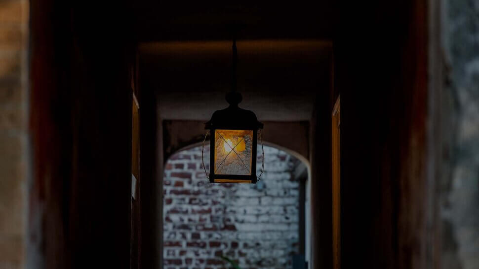 lantern hanging in dark open room